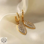 Gold hoop earrings featuring jeweled leaf shape pendants in 18K gold diamond design