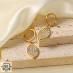 Gold hoop earrings featuring jeweled leaf pendants in 18K Gold Diamond design