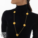 Elegant 18K gold necklace featuring a geometric round honeycomb design and inlaid gemstone