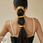 Woman’s black hair adorned with 18K gold geometric U-shaped hair accessories