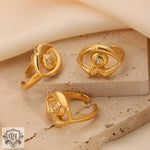 Three 18K gold hip-hop style rings with eye shapes and zircon stones showcasing individual charm