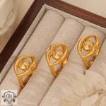 Three gold-colored eye-shaped rings showcasing hip-hop style and individual charm in 18K gold