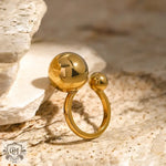 Gold-colored 18k gold ring featuring a small ball design with two spherical beads