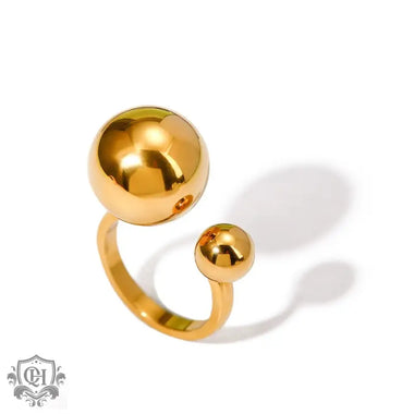 Gold-colored 18k gold ring featuring a small ball design with two spherical beads