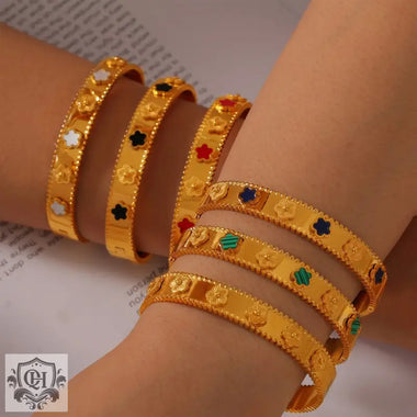 Gold flower-accented bangle bracelets in 18K gold, showcasing light luxury style design