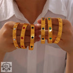 Gold-toned clover-motif bangles in 18K gold, embodying light luxury style elegance