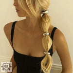 Blonde hair adorned with 18K gold geometric crescent-shaped hair accessories