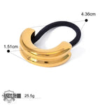 Gold-toned hair tie featuring a double-banded curved metal accent in 18K gold geometric design