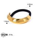 Gold-toned 18K gold hair tie with black elastic in a geometric design for luxurious hair accessories