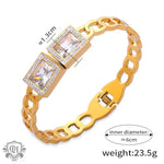 Gold-toned 18K gold chain bracelet with sparkling diamonds and geometric design elements