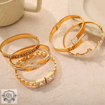 Gold-toned bangles with gemstone accents in 18K gold featuring sparkling diamonds