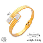 Gold-toned ridged bracelet with sparkling diamonds and elegant 18K gold design elements