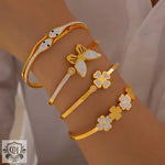 Gold-toned bracelets featuring butterfly, clover, and snake designs in 18K gold light luxury style