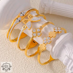 Gold-toned bracelets featuring snake, butterfly, and clover designs in 18K gold light luxury style