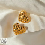 Two 18k gold heart-shaped earrings with a diamond pattern and textured quilted design