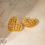 Two gold heart-shaped trinket dishes complementing 18k gold diamond pattern earrings