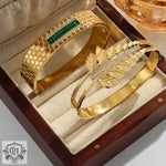 Two 18K gold bracelets featuring unique artistic beauty and hollow designs in a box