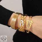 Gold leaf-themed bangle bracelets in 18K gold featuring unique artistic beauty and hollow designs