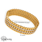 Gold-toned multi-strand bangle bracelet with crystal accents showcasing unique artistic beauty