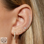 Ear showcasing stunning 18K Gold Inlaid XO Letter Earrings with diamonds