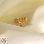 Gold XO stud earrings with rhinestones in 18K gold inlaid design for elegance