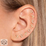 Ear adorned with 18K Gold Inlaid XO Letter Earrings showcasing multiple styles