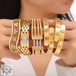 Assortment of high-quality 18K gold bracelets with geometric design elements