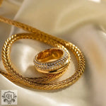 Elegant 18K Gold Multi-Layered Ring featuring shimmering diamond bands