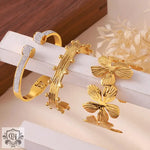 Three elegant 18K gold cuff bracelets featuring a light luxury flower design