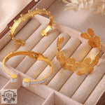 Three gold-toned 18K gold bracelets featuring light luxury geometric flower design