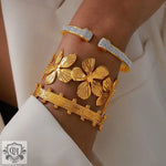 Gold-toned flower design cuff bracelets featuring 18K gold in light luxury style