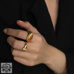 Elegant hand adorned with an exquisite 18K gold ribbed ring showcasing fine craftsmanship