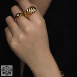 Hand adorned with an 18K Gold Ribbed Ring showcasing elegant gold ribbed design