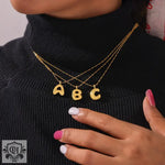 Gold letter pendant necklaces in 18K gold, featuring a light luxury style design