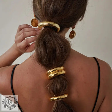 Brown hair styled with 18K gold hair accessory featuring a double-layer design