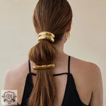 Woman’s hair styled with 18K gold double-layer design hair accessory for elegance