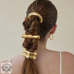 Braided hairstyle featuring 18K gold hair accessory with double-layer design