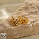 Elegant 18K Gold Snowflake Zircon Earrings featuring intricate gold flower-shaped design