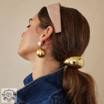 Woman showcasing 18K gold geometric design hair accessories with elegant jewelry