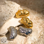 Shiny gold and silver chubby croissant earrings featuring 18k gold texture design