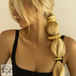 Blonde hair styled with 18K gold trendy U-shaped hair accessories featuring a hammer pattern