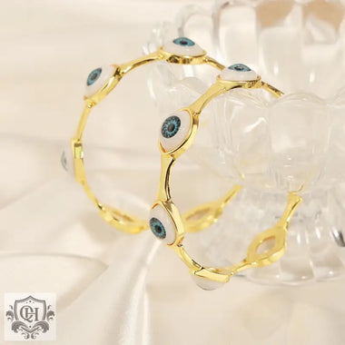 Gold-toned 18K gold hip-hop style devil’s eye design bracelet ring set showcasing eye motifs