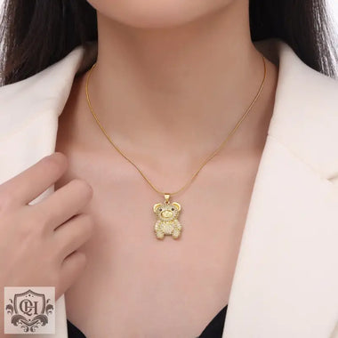 Gold teddy bear pendant necklace featuring 18K gold and bear diamond design