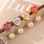 Heart-shaped earrings with lip design and pearl drop in 18K gold jewelry set