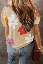 Beige floral t-shirt with bubble sleeves and flower prints paired with blue jeans in Euro sizes