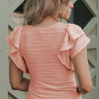 Peach-colored ruched top with ruffled cap sleeves in Euro sizes for a relaxed fit