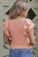 Peach-colored ruched top with ruffled cap sleeves in Euro sizes for a relaxed fit