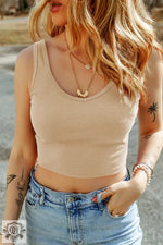 Beige ribbed crop tank top with light wash jeans, featuring optimal bust hem width