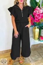 Black two-piece lounge set featuring textured ruffled sleeves and wide leg pants