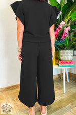 Black two-piece pantsuit featuring textured ruffled sleeves for a stylish, relaxed look